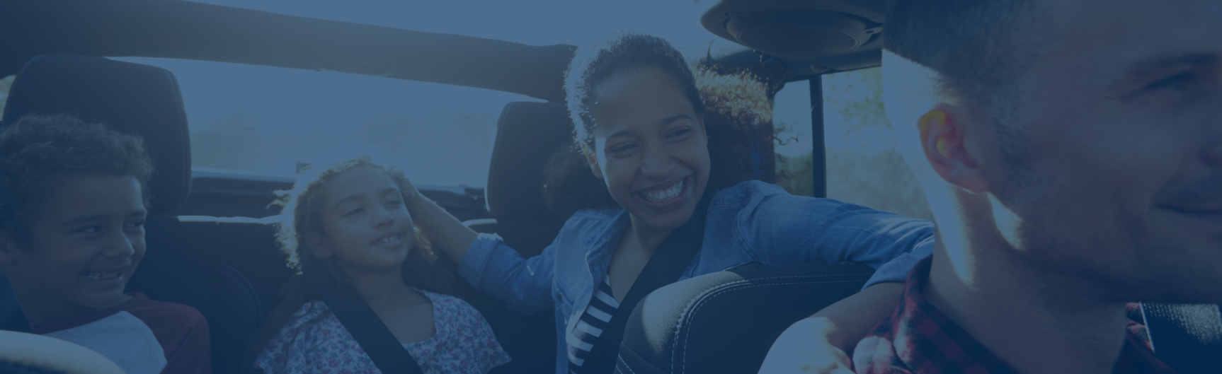 Happy family riding in a car
