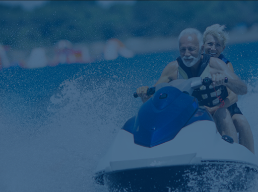 Mature couple riding on a jet ski watercraft