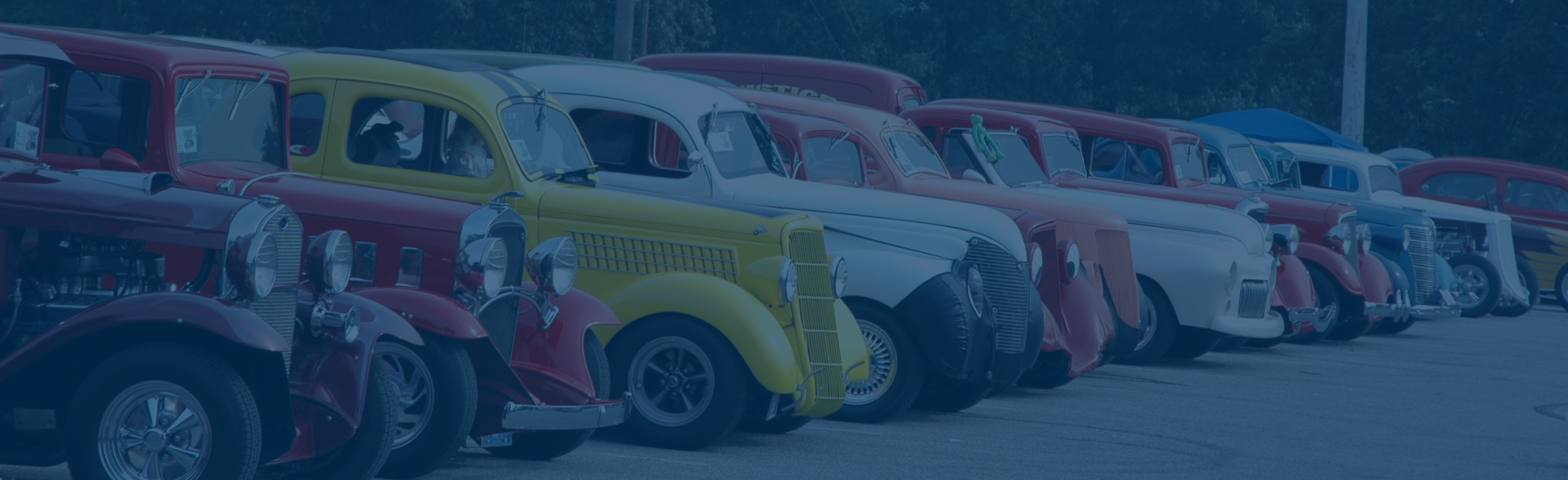 row of classic cars in a parking lot
