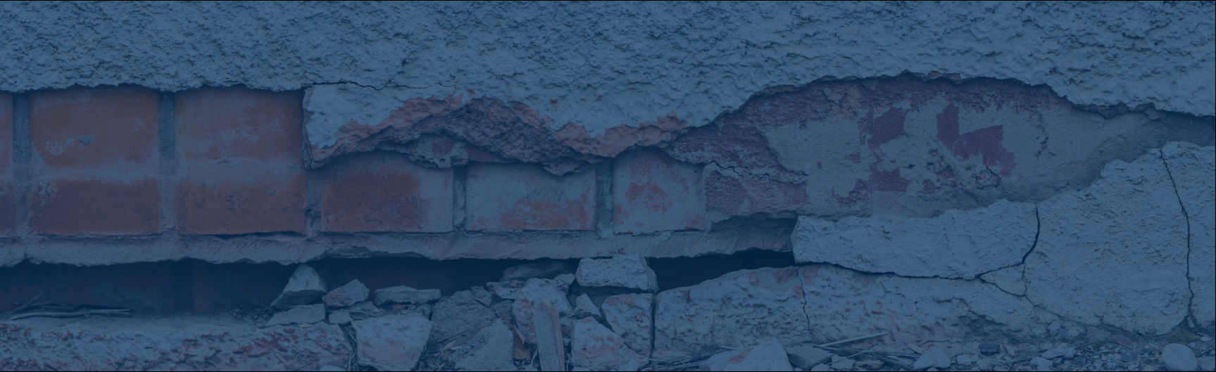 earthquake damaged cracked stucco and brick wall
