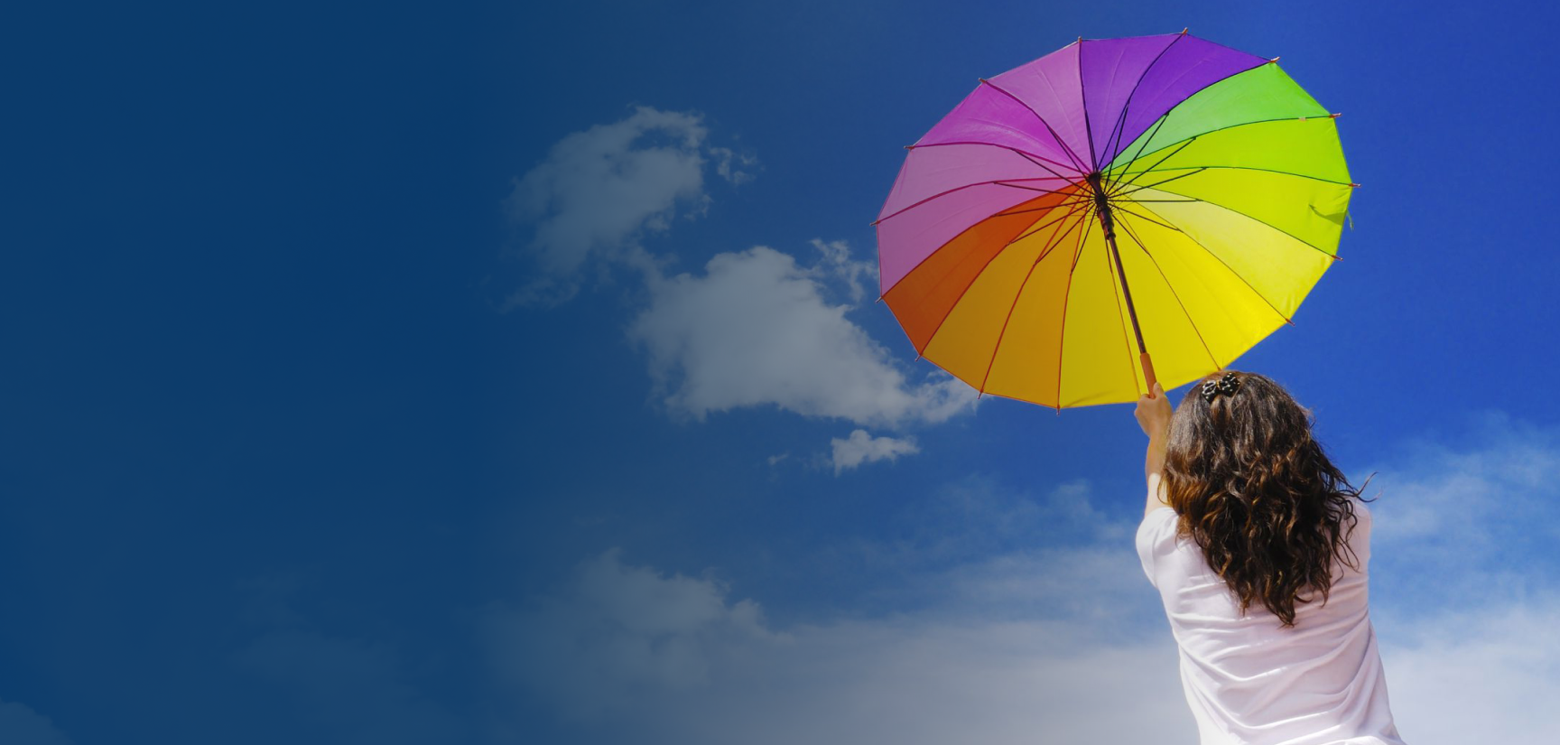 Girl holding a rainbow umbrella