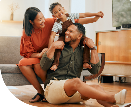 Young, happy family in living room laughing together