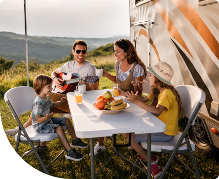 Family enjoying time at a picknick next to their rv