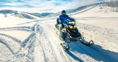 person riding on a snowmobile